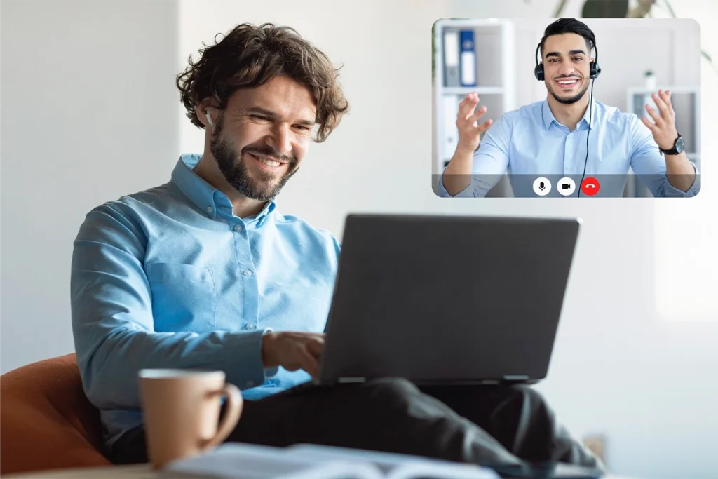 Businessman video calling a remote virtual assistant on his laptop to evaluate hiring agency versus freelance options.